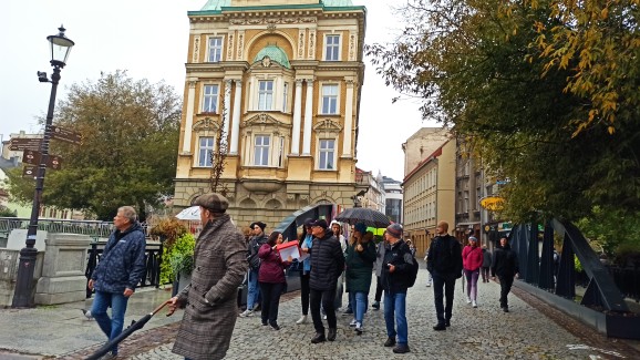 Zdjęcie grupy biorącej udział w spacerze podczas przejścia mostem na rzece Biała.